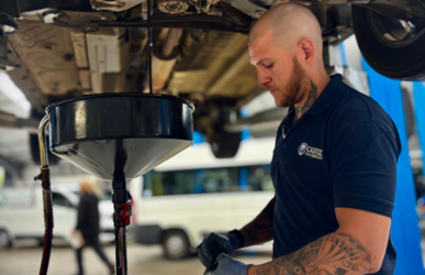 Technician Shaun performing an oil change during routine car servicing at Castle Vehicle Servicing.